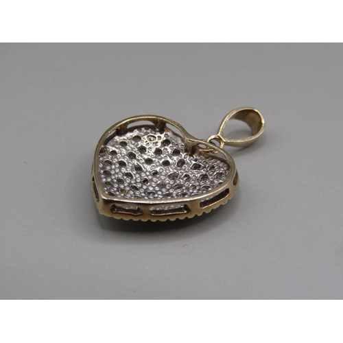 1613 - A 9ct gold pave set diamond heart shaped pendant with hanger.