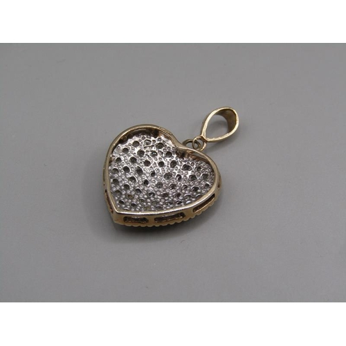 1613 - A 9ct gold pave set diamond heart shaped pendant with hanger.