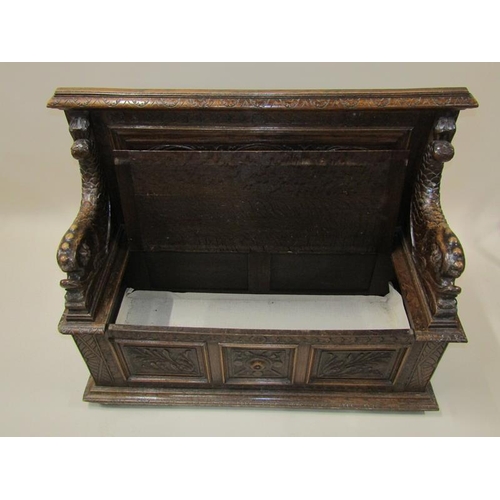 2014 - A Victorian oak box seat, the panel profusely carved with a central warrior flanked by scrolling lea... 