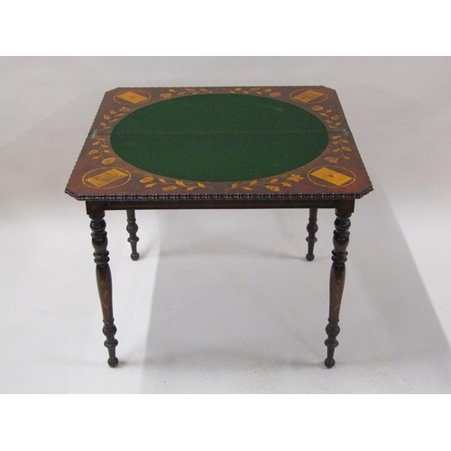 2055 - An early 19c mahogany marquetry decorated fold over card table, the open top with trump card corners... 