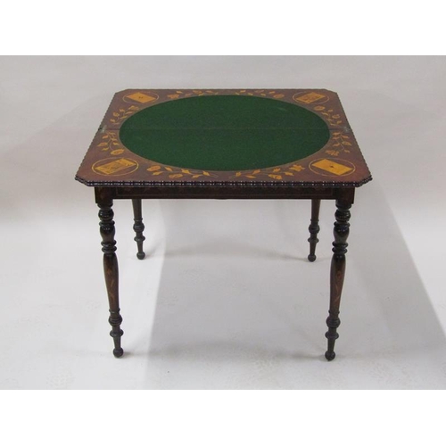 2055 - An early 19c mahogany marquetry decorated fold over card table, the open top with trump card corners... 