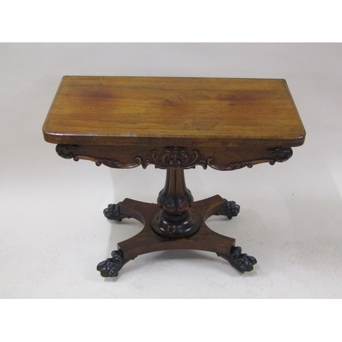 2059 - A William IV rosewood fold over card table with a deep carved and moulded frieze, supported on a lob... 