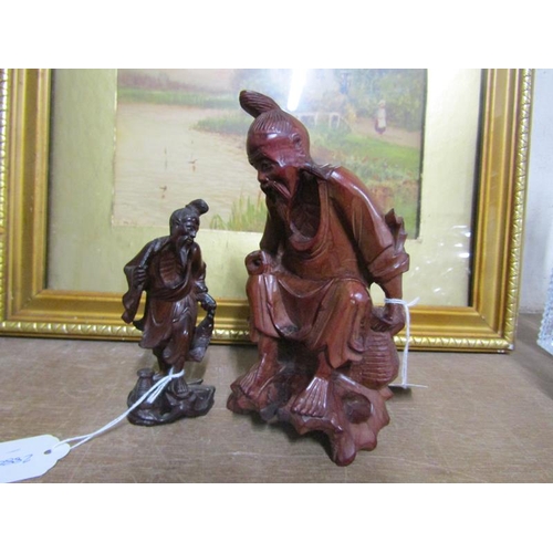 34 - TWO CARVED WOODEN ORIENTAL FIGURES