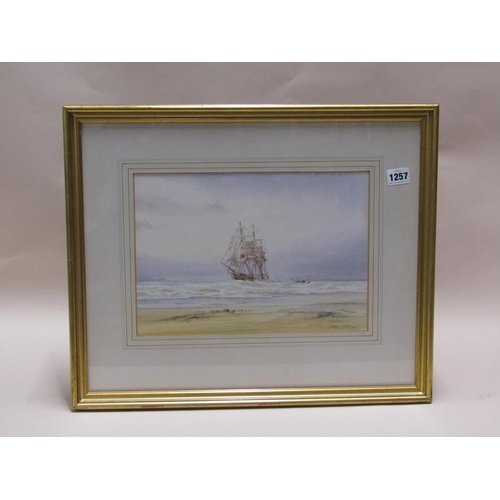 1257 - DAVID G BELL - ANCHORED SAILING VESSEL CLOSE TO THE BEACH.  SIGNED WATERCOLOUR, F/G 24 x 33 cms