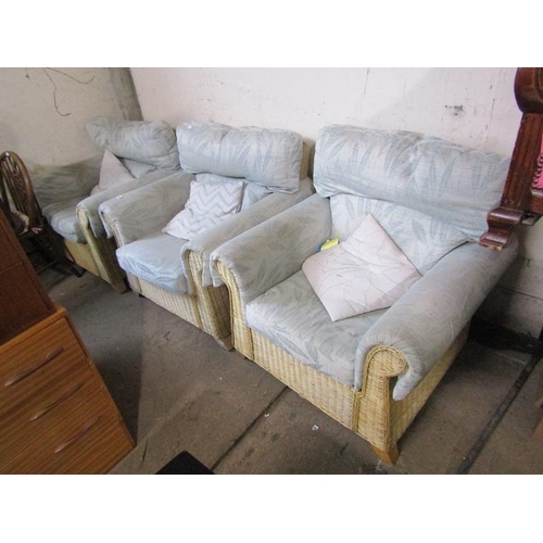 556 - THREE WICKER UPHOLSTERED ARMCHAIRS