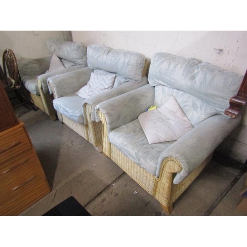 556 - THREE WICKER UPHOLSTERED ARMCHAIRS