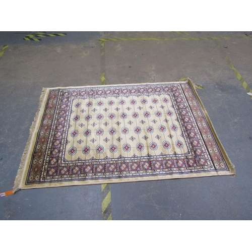 1742 - GOLD GROUND KASHMIR BOKHARA DESIGN RUG, 170CM X 120CM