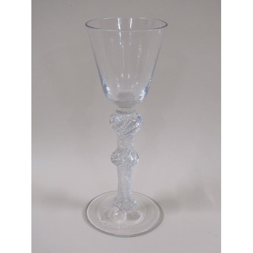 119 - An 18c wine glass with a round funnel bowl, double knopped air twist stem and domed circular foot, 1... 