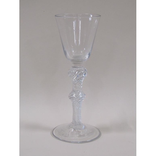 119 - An 18c wine glass with a round funnel bowl, double knopped air twist stem and domed circular foot, 1... 