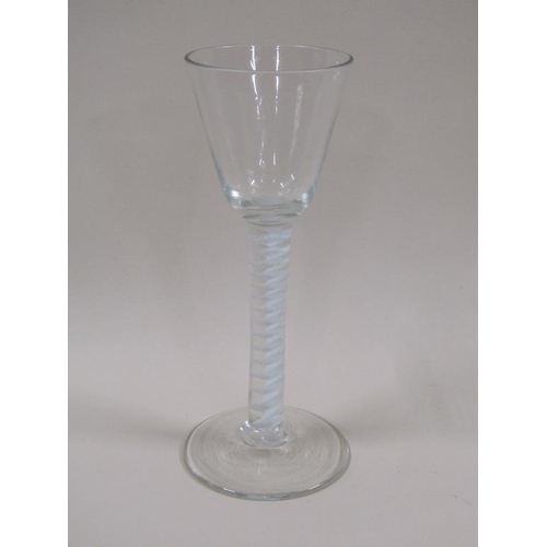 121 - An 18c wine glass with round funnel bowl having a white opaque multi twist stem and a domed circular... 