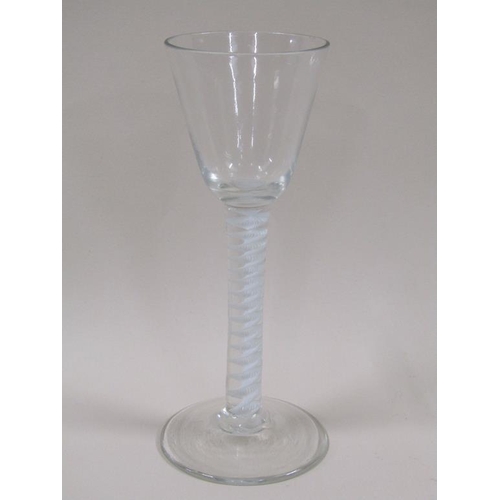 121 - An 18c wine glass with round funnel bowl having a white opaque multi twist stem and a domed circular... 