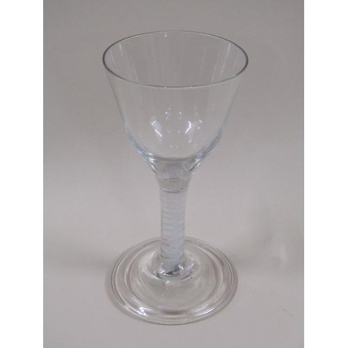 122 - An 18c wine glass with ogee bowl, white opaque spiral band stem on a circular domed and folded foot,... 