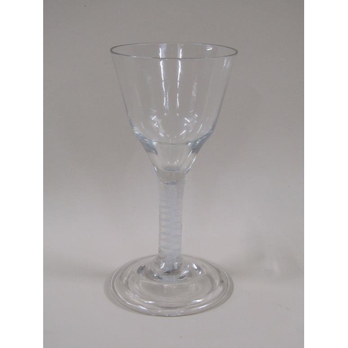 122 - An 18c wine glass with ogee bowl, white opaque spiral band stem on a circular domed and folded foot,... 