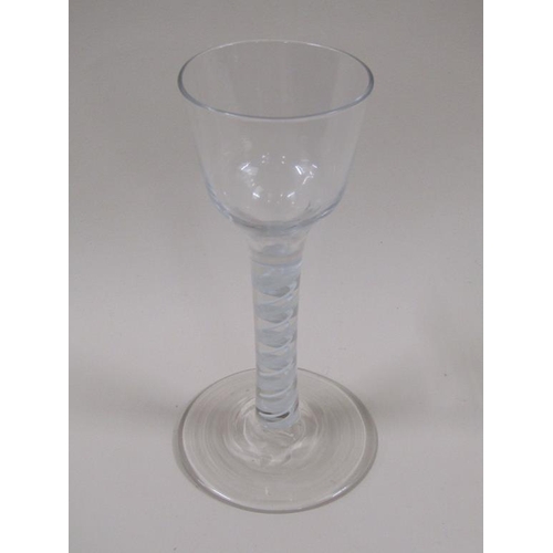 123 - An 18c wine glass with a round funnel bowl on a multi twist opaque white spiral stem with outside la... 