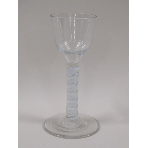 123 - An 18c wine glass with a round funnel bowl on a multi twist opaque white spiral stem with outside la... 