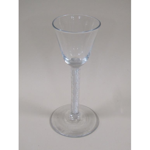 125 - An 18c wine glass with a round funnel bowl on opaque twist stem surrounding a multi twist on a circu... 