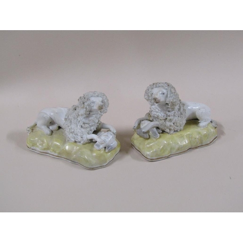 141 - A pair of 19c Staffordshire poodles, each with a bird, painted yellow bases, 7cm h.