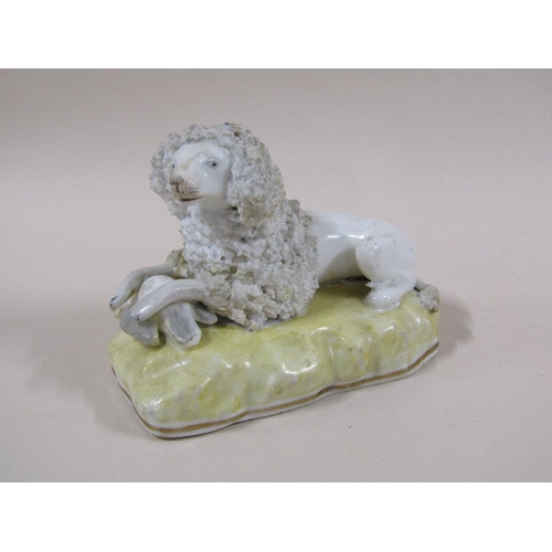 141 - A pair of 19c Staffordshire poodles, each with a bird, painted yellow bases, 7cm h.