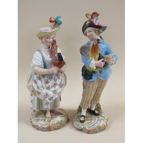 143 - A pair of 19c Meissen porcelain figures of a man and a lady, man holding a cockerel, lady holding a ... 