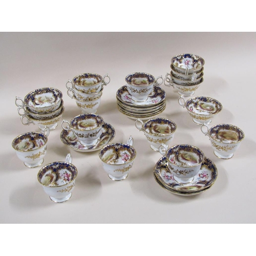 145 - An early 19c Rockingham style part tea service with hand painted panels of various landscapes and bu... 