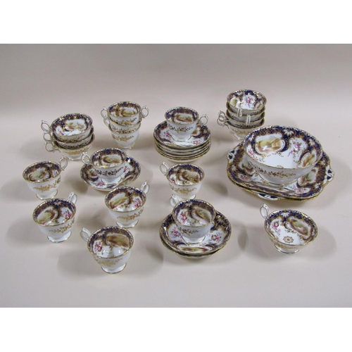 145 - An early 19c Rockingham style part tea service with hand painted panels of various landscapes and bu... 