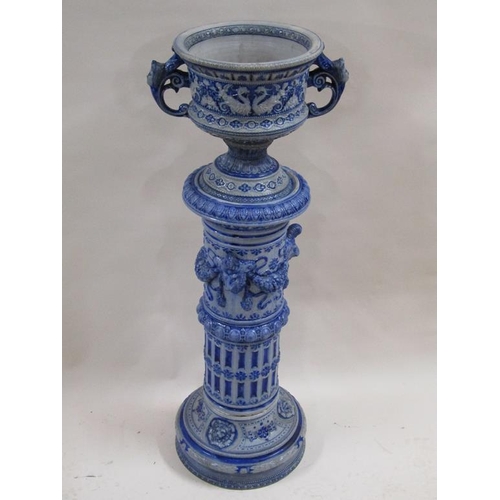 146 - A 19c German saltglazed jardiniere on plinth, blue glazed on grey background moulded with rams head ... 