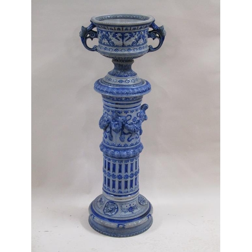 146 - A 19c German saltglazed jardiniere on plinth, blue glazed on grey background moulded with rams head ... 