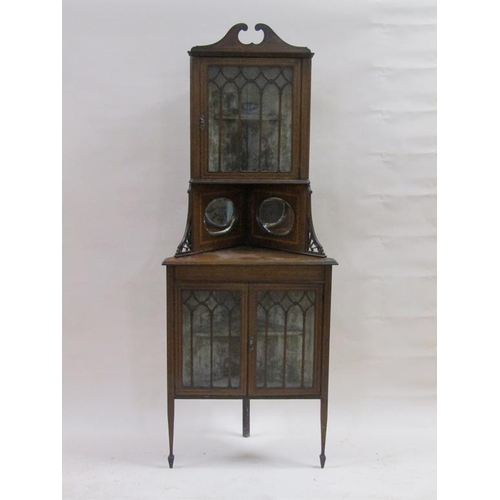 254 - A late Victorian/Edwardian mahogany standing corner cupboard, the upper glazed cabinet with broken a... 