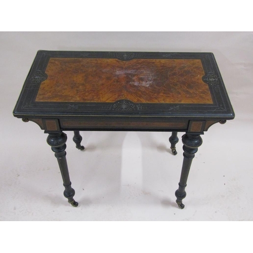 255 - A late Victorian burr walnut and ebonised fold over card table with beaded brass edge mounts, suppor... 