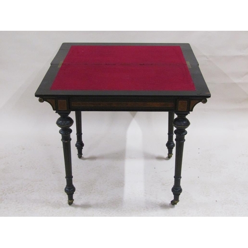 255 - A late Victorian burr walnut and ebonised fold over card table with beaded brass edge mounts, suppor... 