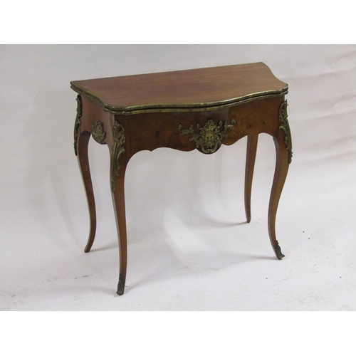 268 - A 19c walnut fold over card table of serpentine form with ormolu mounts and supported on cabriole le... 