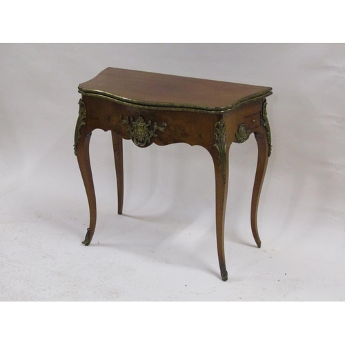 268 - A 19c walnut fold over card table of serpentine form with ormolu mounts and supported on cabriole le... 