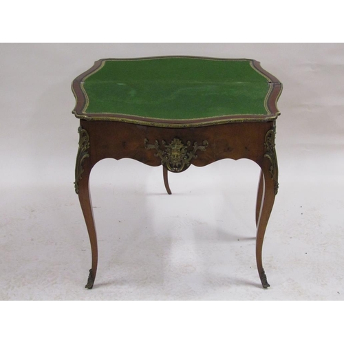 268 - A 19c walnut fold over card table of serpentine form with ormolu mounts and supported on cabriole le... 