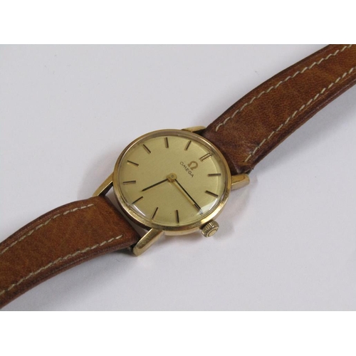 52 - A ladies Omega wristwatch with gold case movement and brown leather strap.