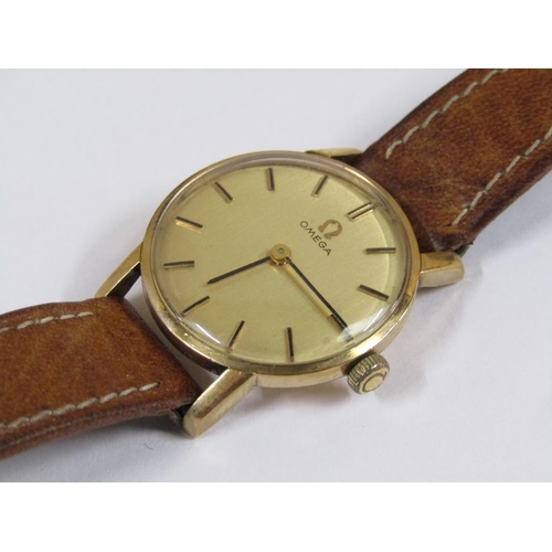 52 - A ladies Omega wristwatch with gold case movement and brown leather strap.