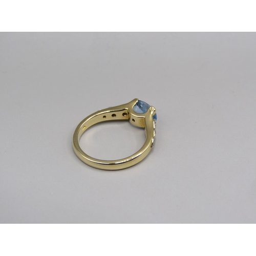 57 - An 18ct gold aquamarine and diamond set ring, size N.