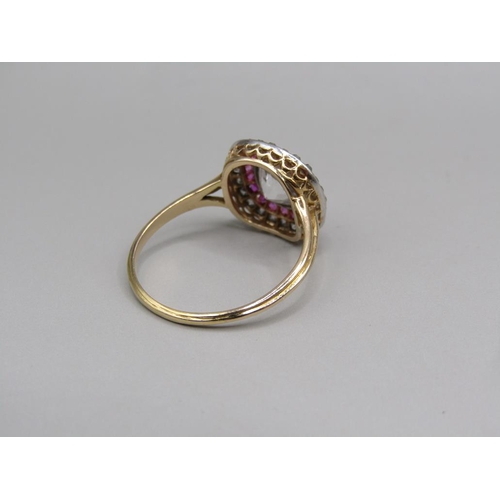 59 - A gold diamond and ruby set ring, the principal stone approx. 1.25carats, size O.