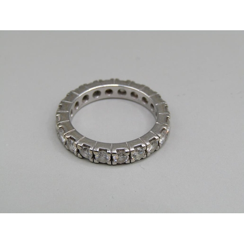 60 - A platinum diamond set eternity ring, set with twenty cut diamonds, size K 1/2.