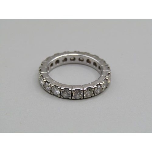 60 - A platinum diamond set eternity ring, set with twenty cut diamonds, size K 1/2.