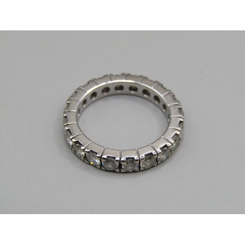 60 - A platinum diamond set eternity ring, set with twenty cut diamonds, size K 1/2.