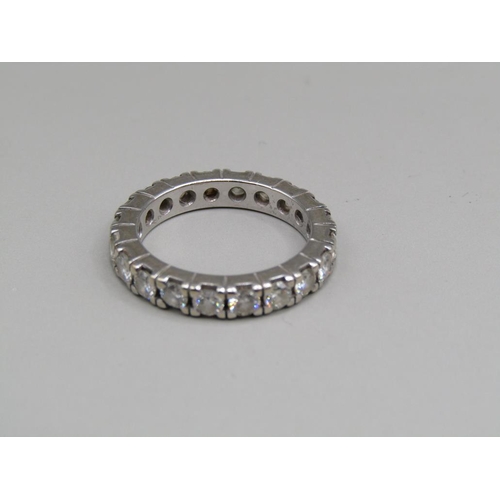 60 - A platinum diamond set eternity ring, set with twenty cut diamonds, size K 1/2.