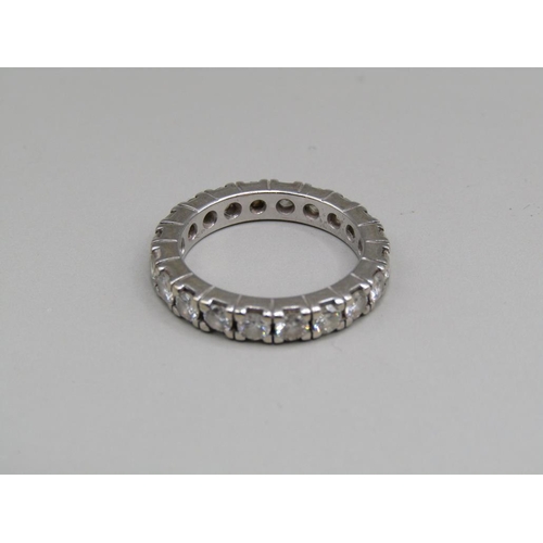 60 - A platinum diamond set eternity ring, set with twenty cut diamonds, size K 1/2.