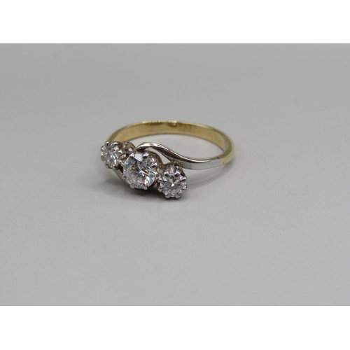 64 - An 18ct gold diamond trilogy crossover ring, central stone 1/2ct, size M.