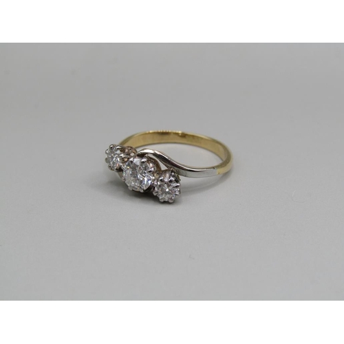 64 - An 18ct gold diamond trilogy crossover ring, central stone 1/2ct, size M.