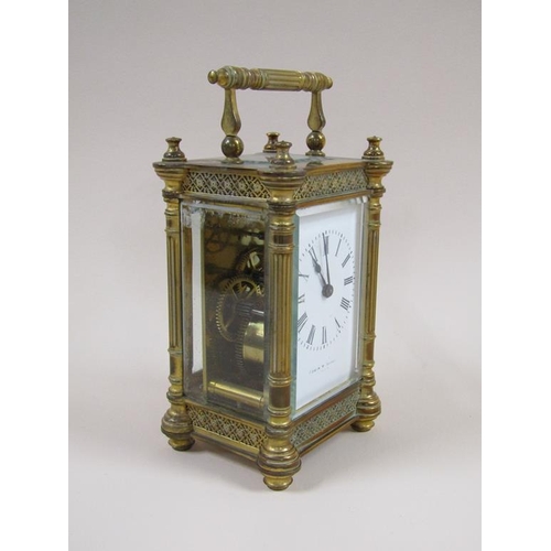 7 - A late 19c French carriage clock in decorated columned brass case, the white rectangular enamel dial... 