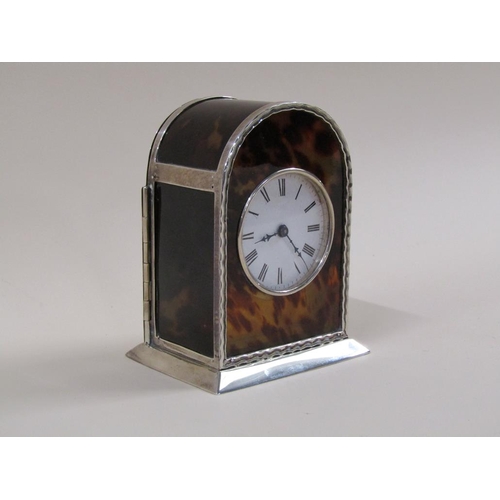 8 - An early 20c French carriage clock in 'hump back' silver case with tortoiseshell panels to front sid... 