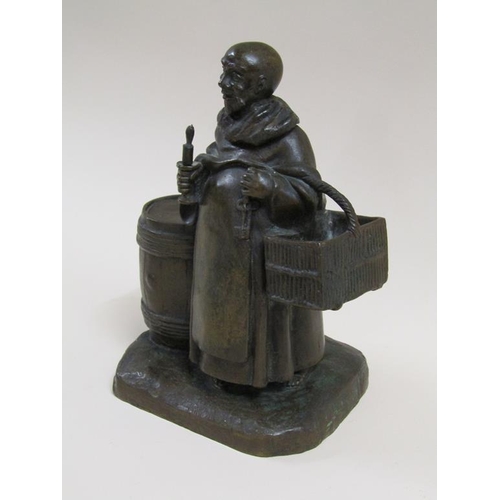 24 - A 19c style patinated bronze figure group of the Merry Monk, he carrying candle and basket, standing... 