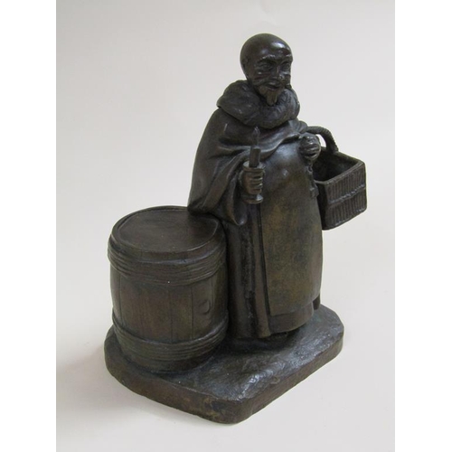 24 - A 19c style patinated bronze figure group of the Merry Monk, he carrying candle and basket, standing... 