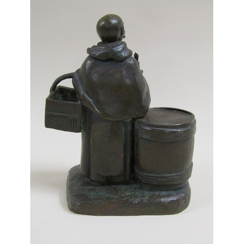 24 - A 19c style patinated bronze figure group of the Merry Monk, he carrying candle and basket, standing... 