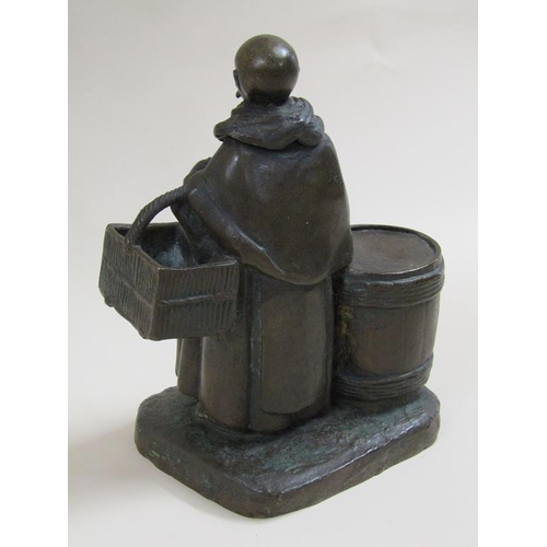 24 - A 19c style patinated bronze figure group of the Merry Monk, he carrying candle and basket, standing... 